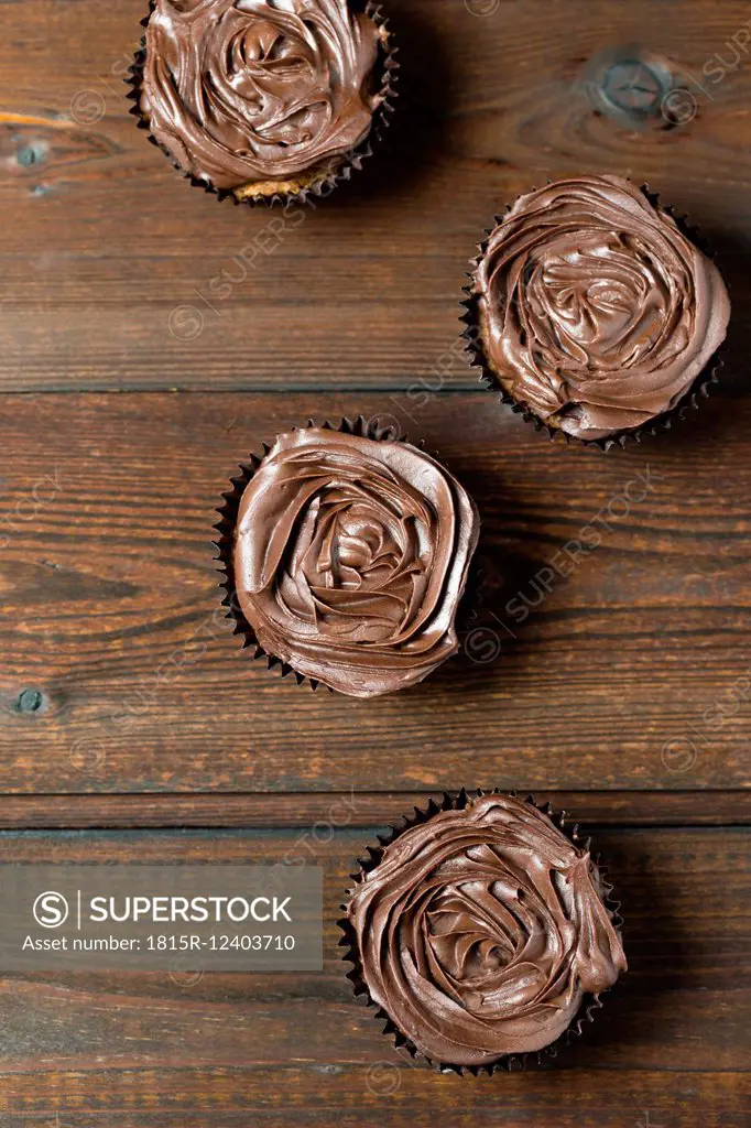 Four cupcakes with chocolate ganache