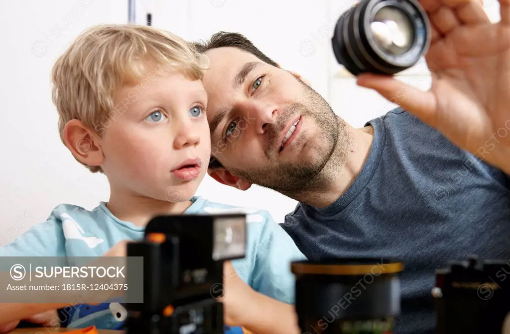 Father explaining analogue camera to son