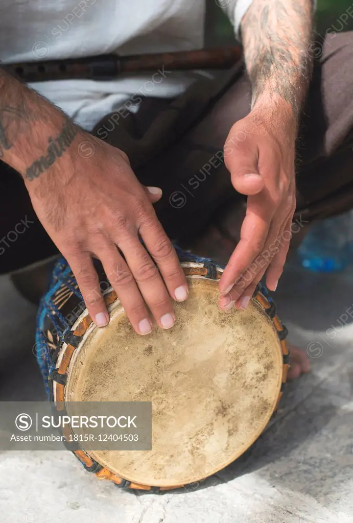Hands of drumming street musician