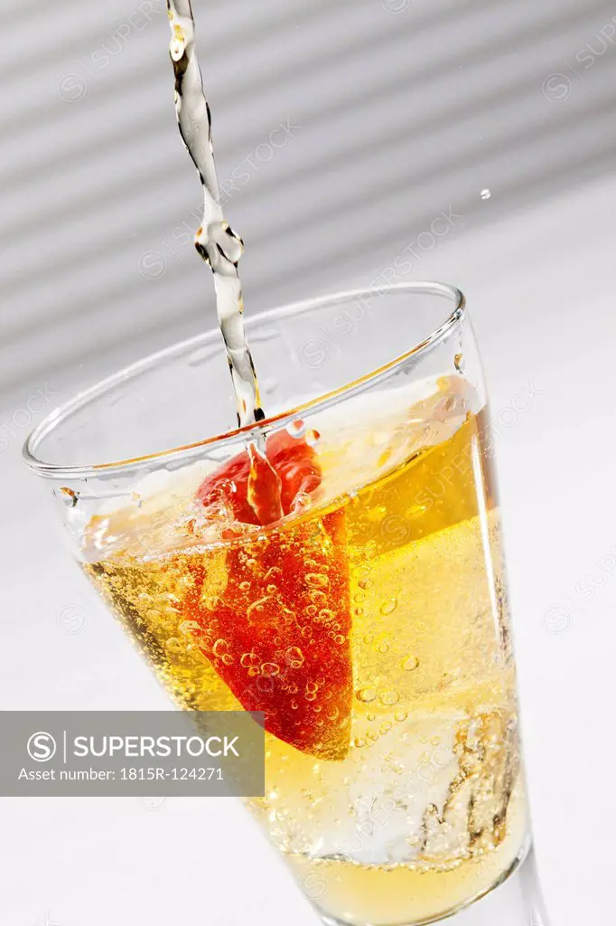 Apple juice with sparkling water and slice of apple in glass, close up