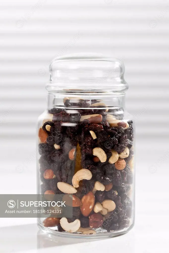 Variety of nuts and raisins in jar, close up