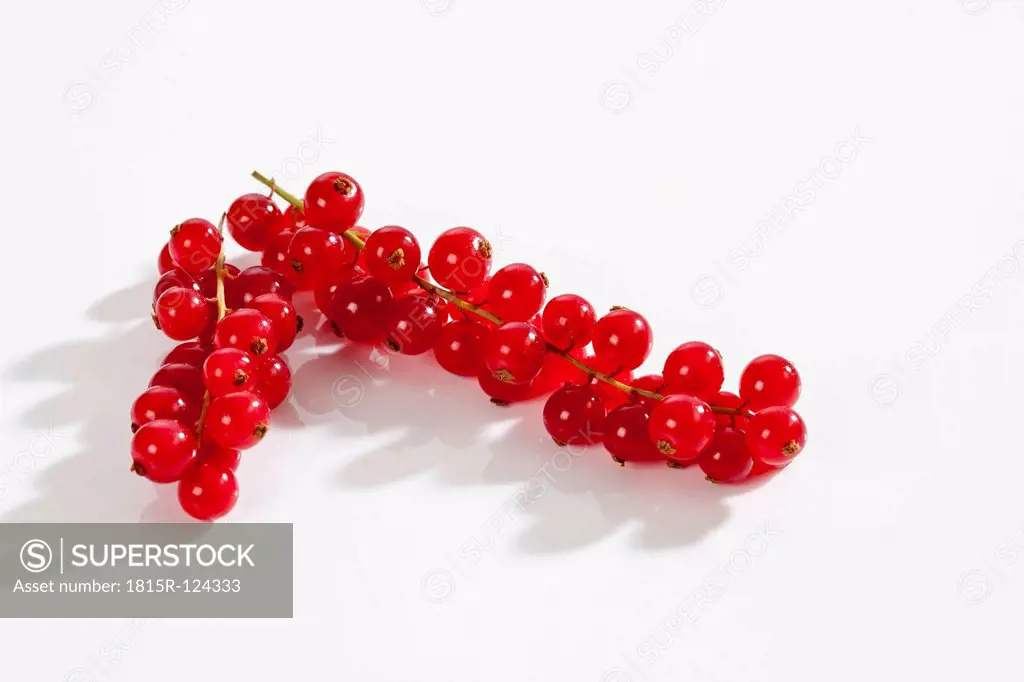 Red currants on white background, close up