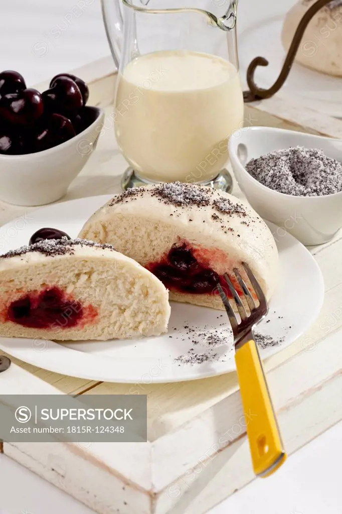 Yeast dumplings with cherry filling, poppy seed and vanilla sauce
