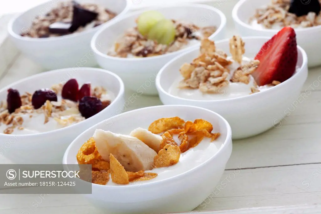 Bowls of yogurt with muesli and fruits