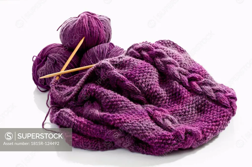 Ball of yarn with needlecraft and knitting needles on white background