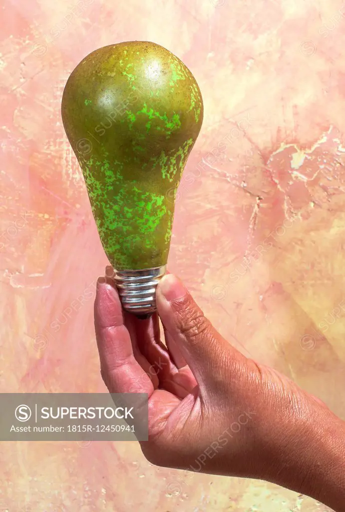 Hand holding pear with bulb fitting