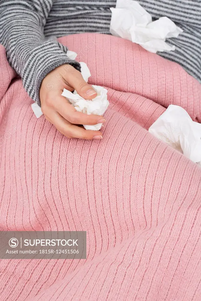 Close-up of sick woman with tissues