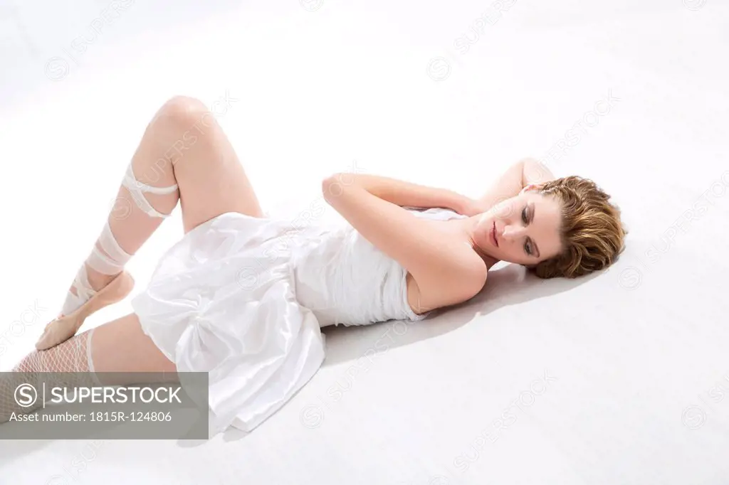 Young ballet dancer relaxing on floor