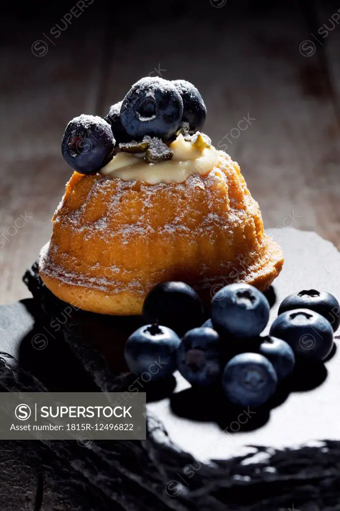 Mini Gugelhupf filled with ricotta and cream cheese garnished with blueberries