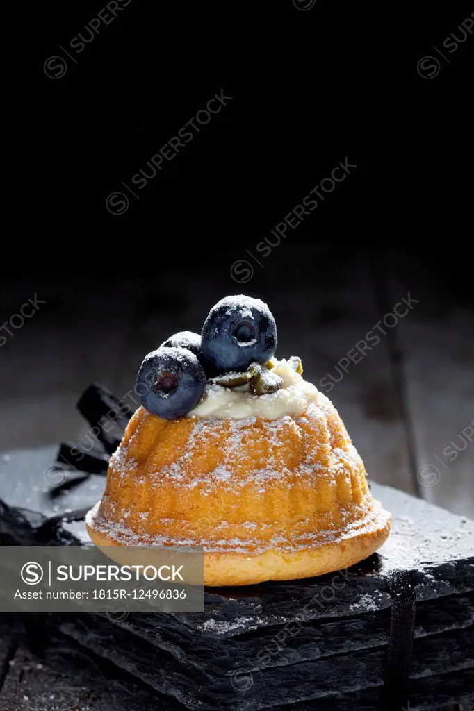 Mini Gugelhupf filled with ricotta and cream cheese garnished with blueberries