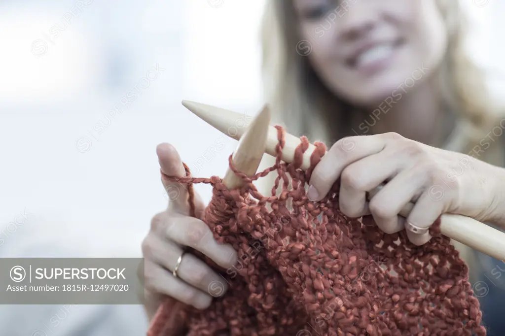 Close-up of woman knitting a blanket