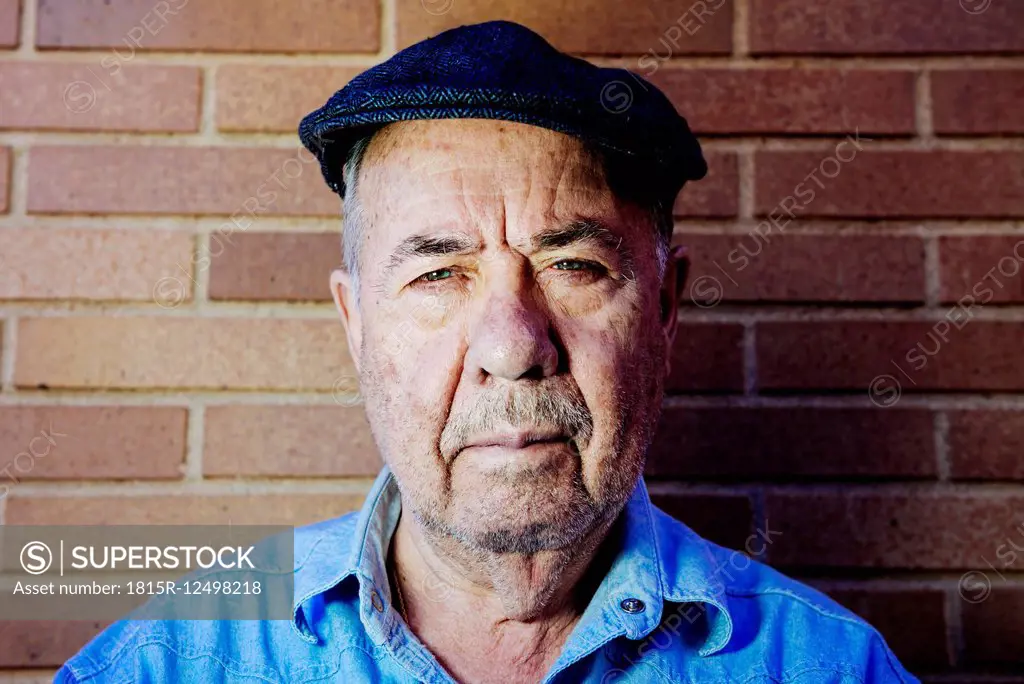 Portrait of serious old man wearing beret