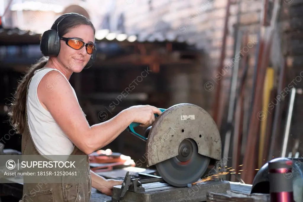 Female welder working in metal workshop