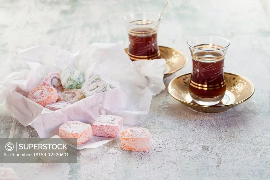 Two glasses of Turkish black tea and sweets