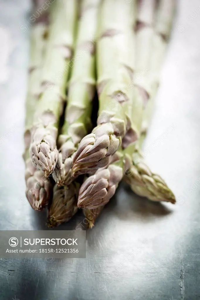 Green asparagus on metal plate