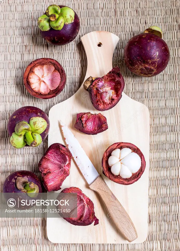Whole and opened mangosteens