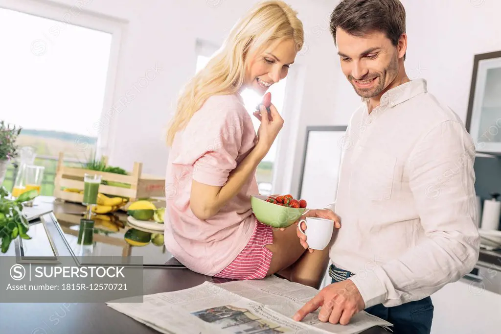 Couple having breakfast in the kitchen