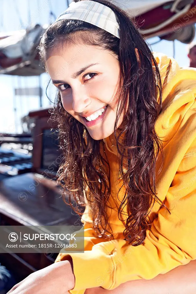 Portrait of smiling young woman on a sailing ship