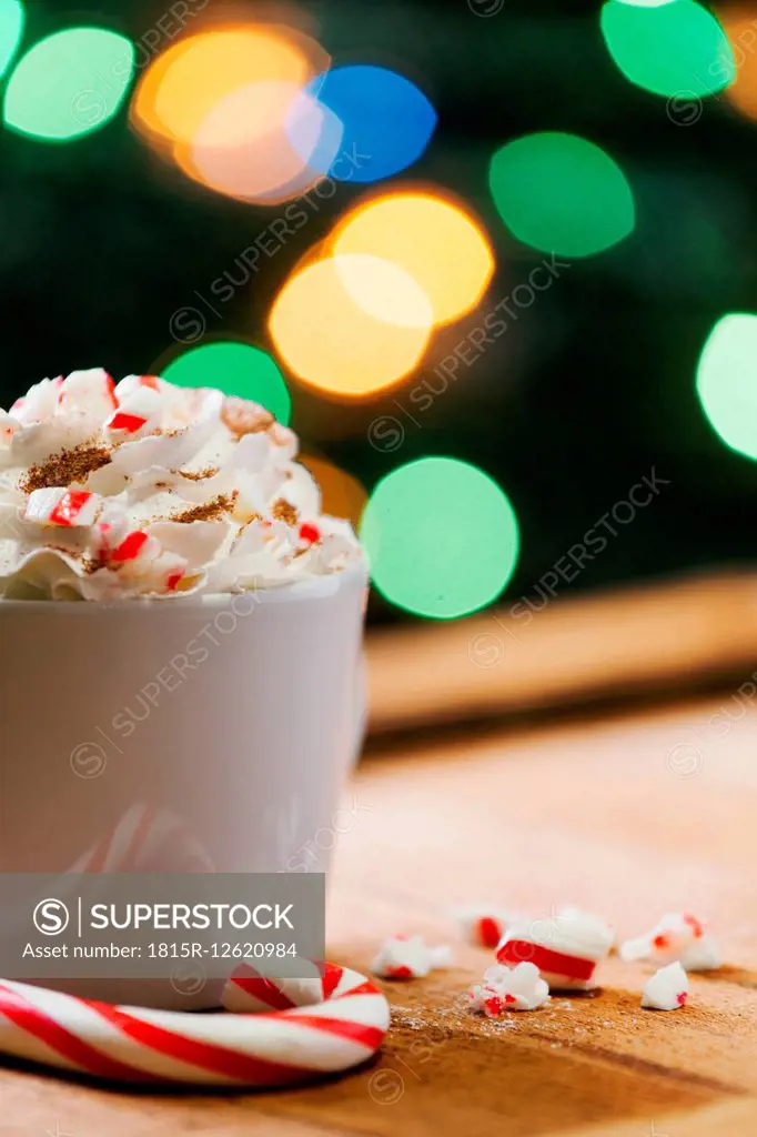 Cup of cappuccino with whipped cream and candy cane