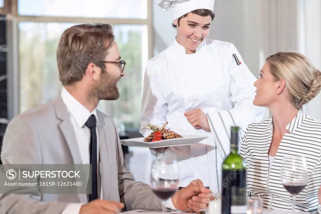 Chef serving food for mid adult couple