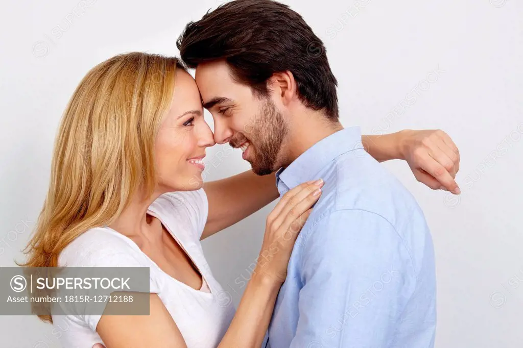 Portrait of loving couple in front of white background