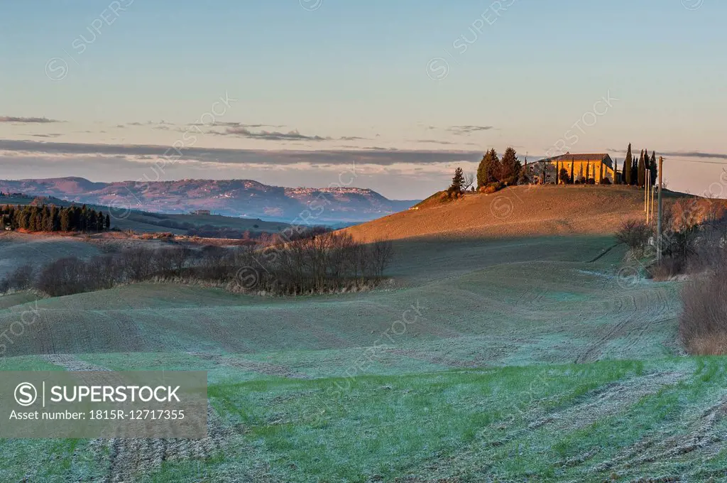 Italy, Tuscany, Val d'Orcia, view to landscape with residential house on a hill
