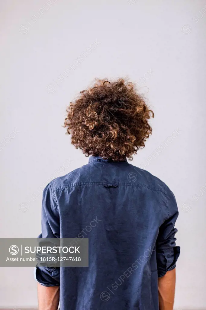 Back view of man with curly hair