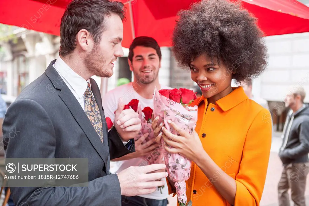 Man buying red roses for a woman