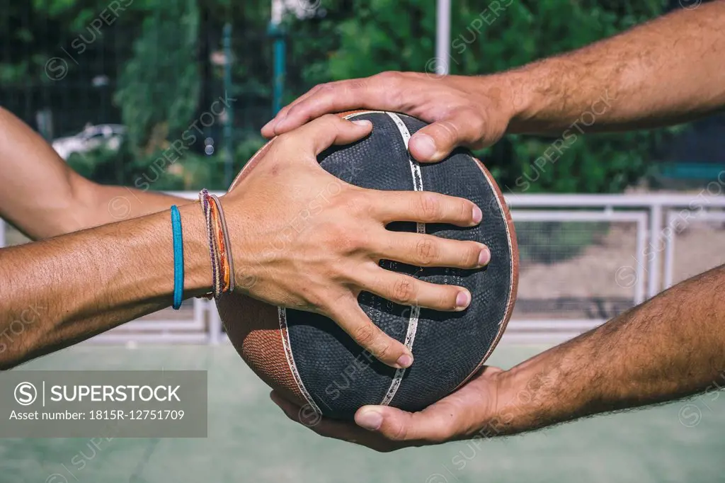 Men holding basketball