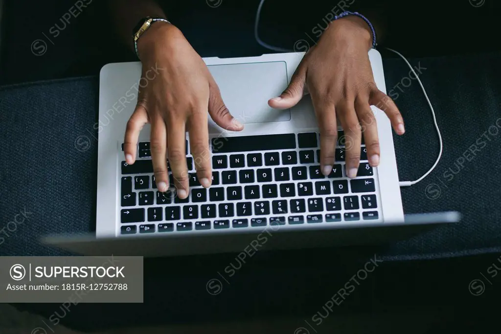 Woman's hand typing on keyboard of laptop