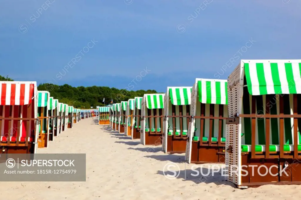 Germany, Boltenhagen, two rows of hooded beach chairs at beach