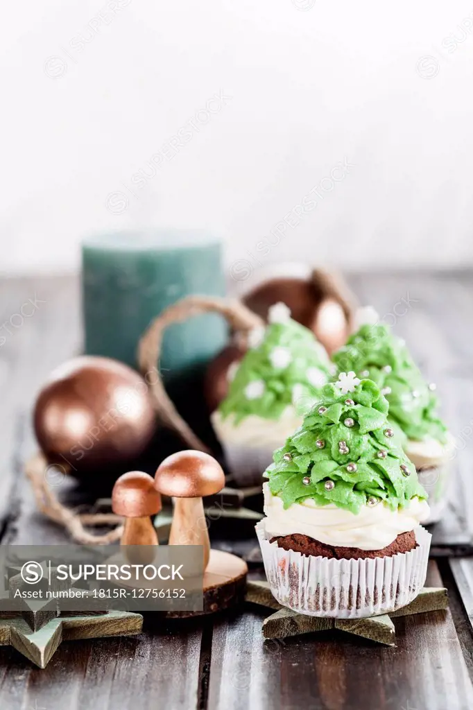 Christmas tree cup cakes and Christmas decoration on festive table