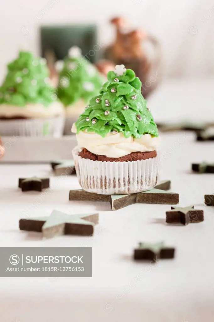 Christmas tree cup cakes and Christmas decoration on festive table