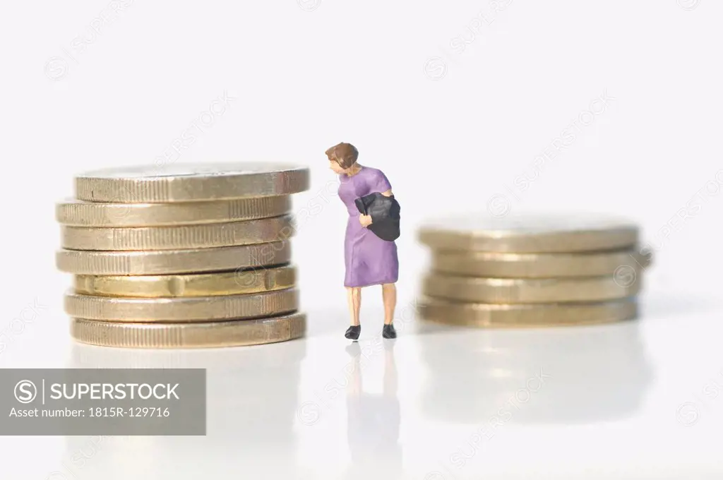 Stack of euro coins with figurine on white background