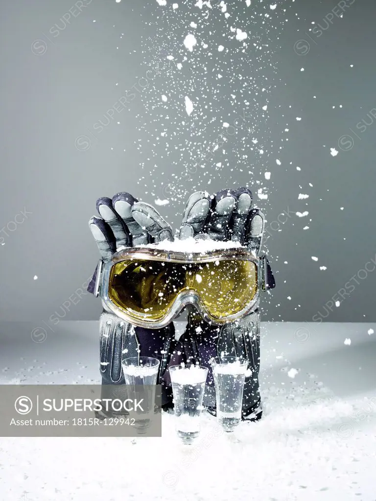 Ski goggles, gloves with drinks on ice