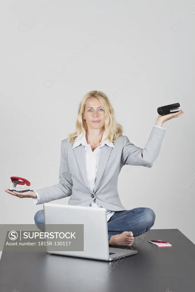 Portrait of businesswoman performing office yoga