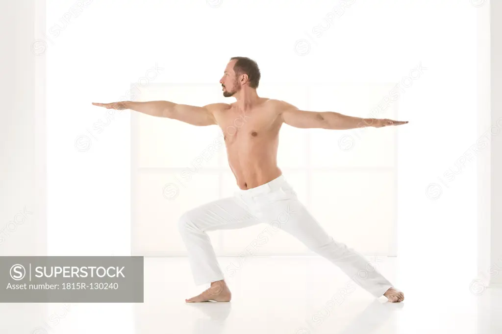 Mature man exercising warrior pose