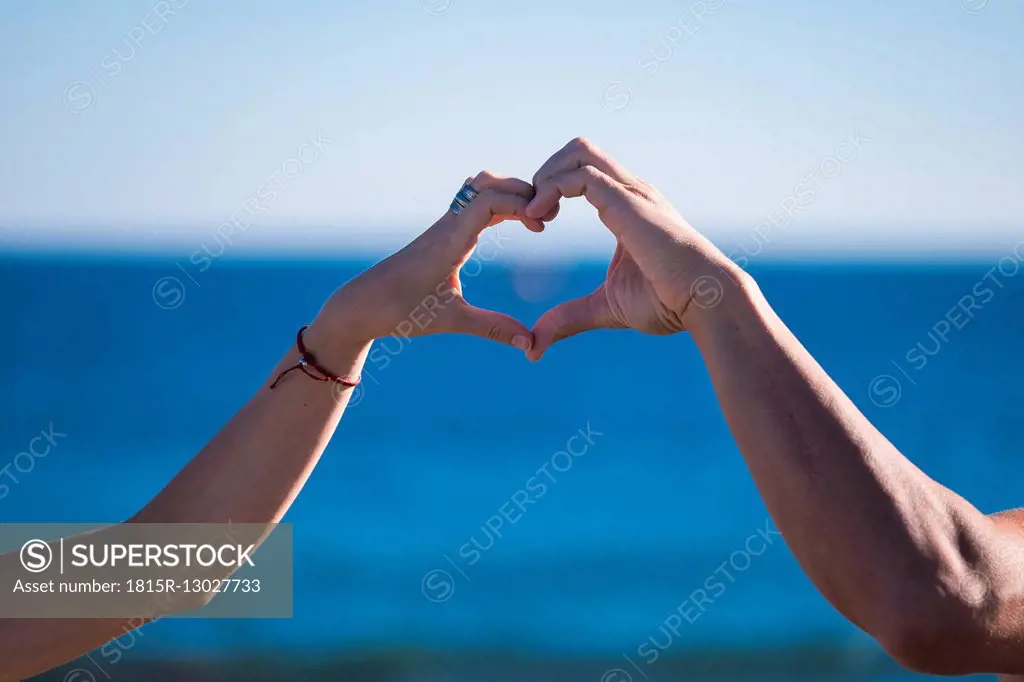 Spain, Tenerife, hands of couple building a heart
