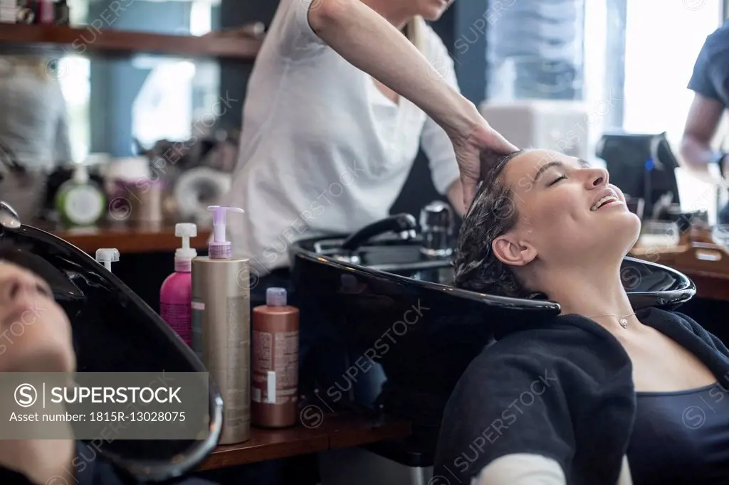 Woman in hair salon getting hair washed