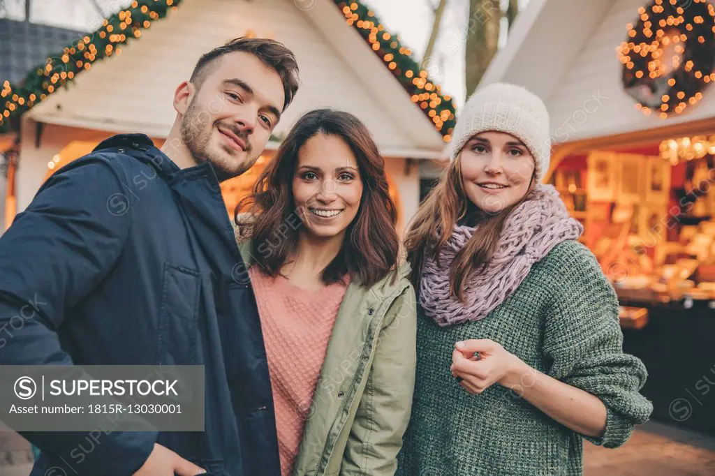 Portrait of three friends on the Christmas Market