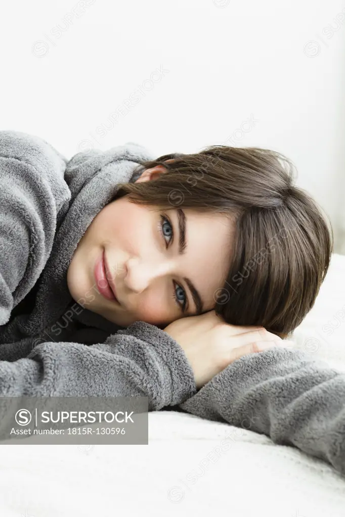 Germany, Bavaria, Munich, Portrait of young woman relaxing, smiling