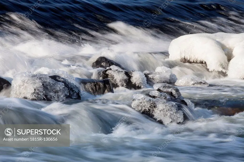 Germany, Hesse, Ice on boulder in river