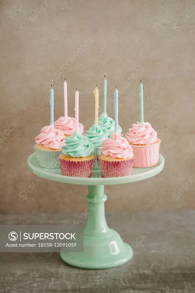 Cup cakes with candles on a cake stand