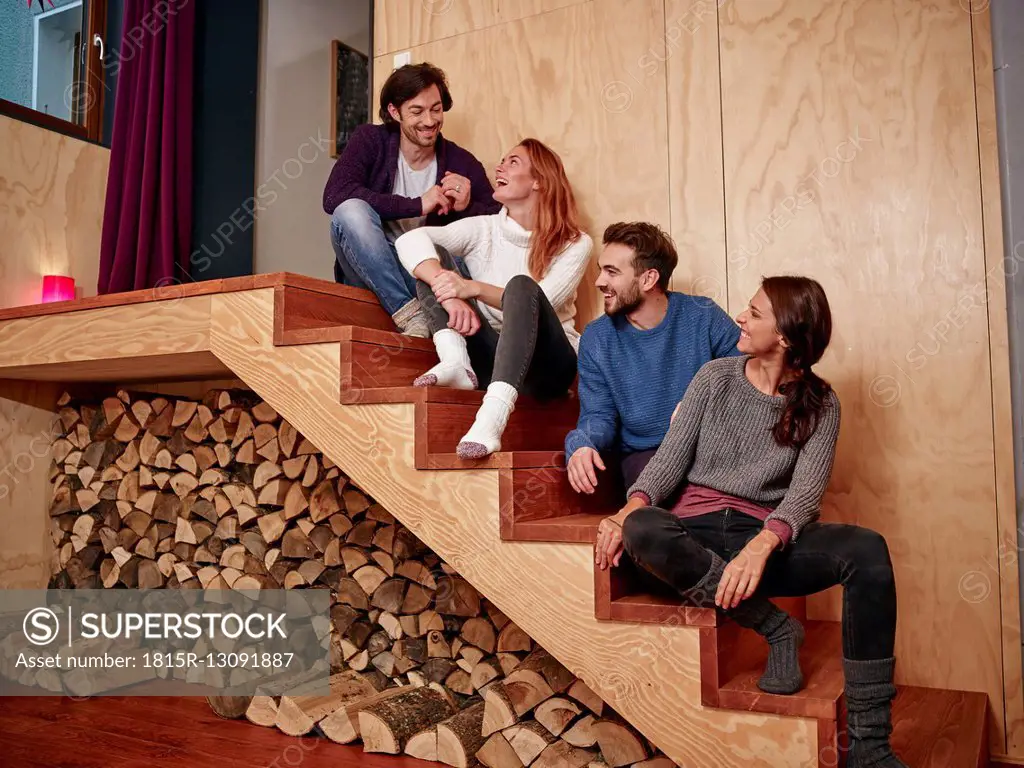 Friends sitting on wooden stairs having fun