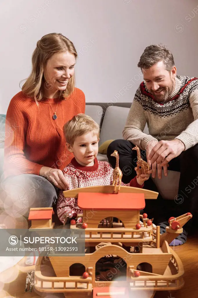 Little boy and his parents playing with Noah's Ark