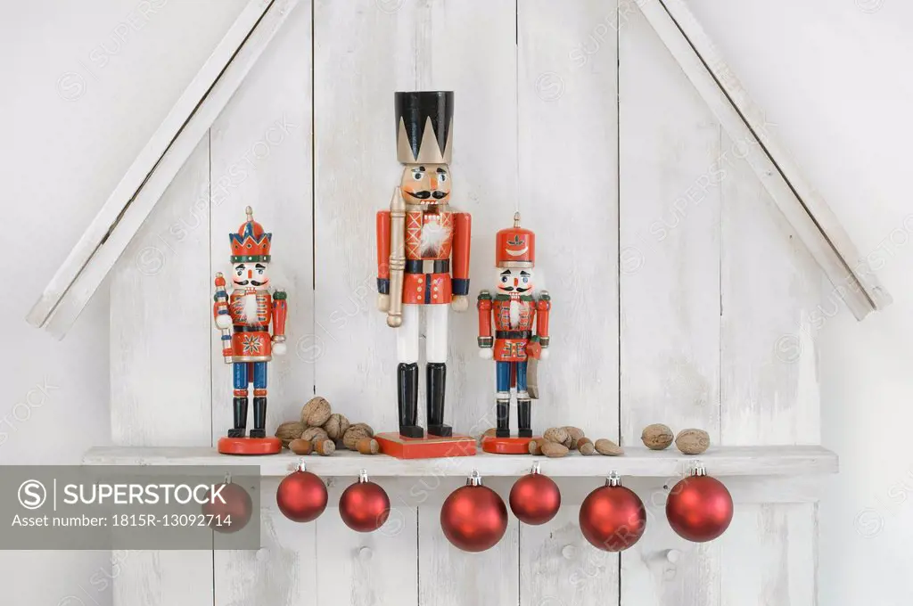 Christmas decoration with three nutcrackers, Christmas baubles and nuts
