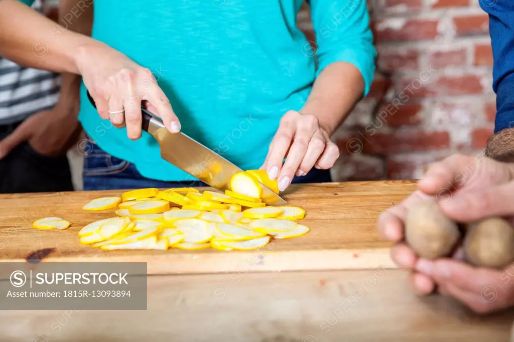 Slicing yellow courgette