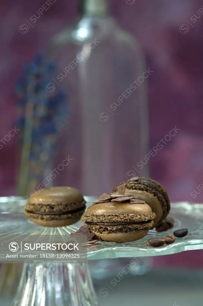 Chocolate macarons, coffee beans and chocolate chips on cake stand