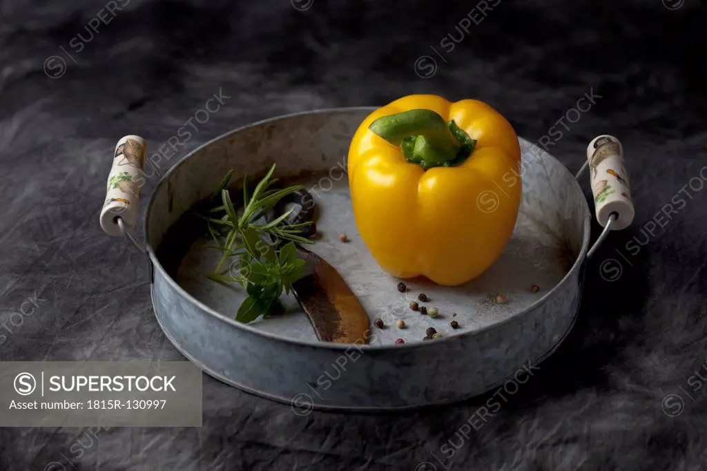 Capsicum with knife and peppers on tray, close up