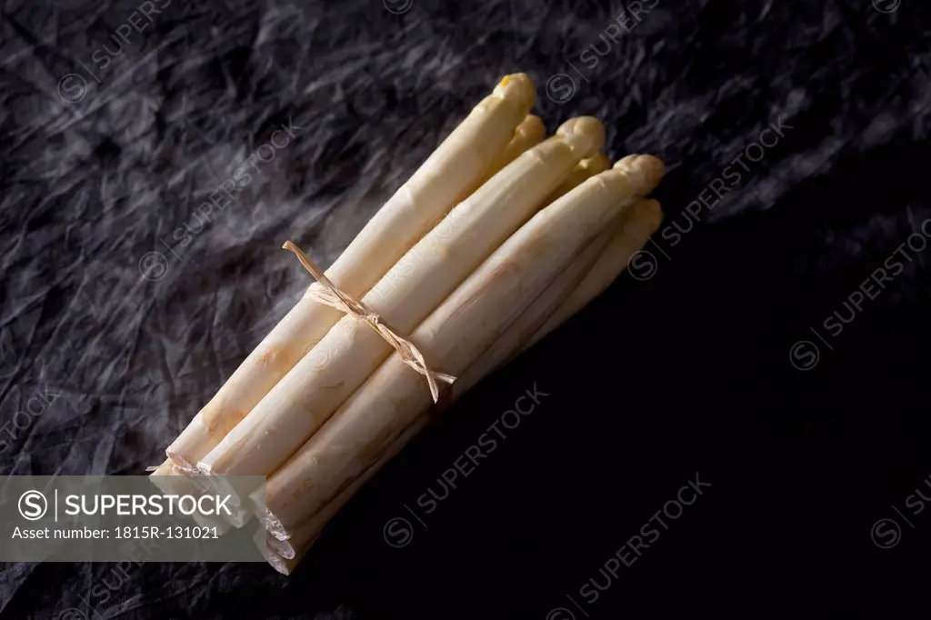 Bunch of white asparagus on textile, close up